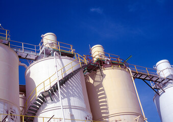 Chemical storage tanks against a blue sky