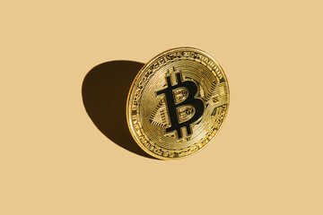 Bitcoin on beige background with shadow