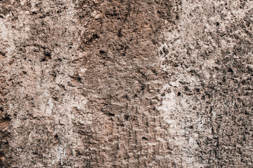 Brown wall texture. Stone background. Rock texture. Grunge Rough structure. Abstract texture. Rock surface with cracks. Rock pile. Paint spots.