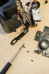 Disassembled compact camera. Internal parts of the broken camera being repaired in the workshop. Selective focus