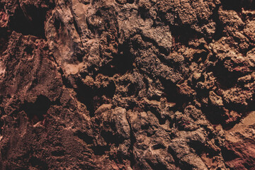 Brown wall texture. Stone background. Rock texture. Grunge Rough structure. Abstract texture. Rock surface with cracks. Rock pile. Paint spots.