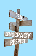 Wooden road sign with words peace, democracy, respect