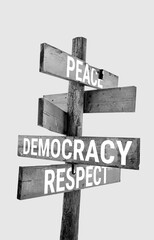 Wooden road sign with words peace, democracy, respect