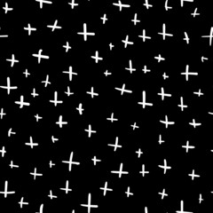 Seamless texture of hand-drawn white crosses on a black square background