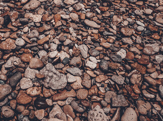 Brick brown. Rock pile. Rock background. Rock texture. Stone background. Paint spots. Rock surface with cracks. Grunge Rough structure. Abstract texture.