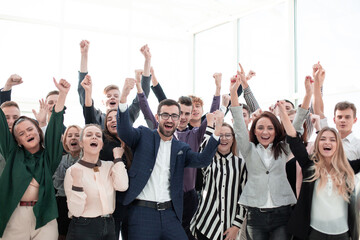 Fototapeta premium happy group of young employees with hands up