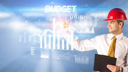 Young businessman with helmet drawing on virutal screen