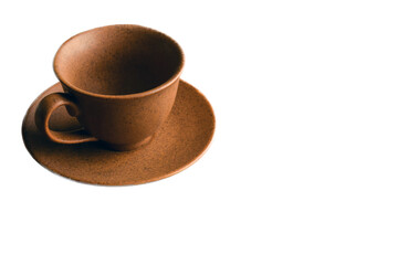 Ceramic brown cup for coffee or tea on a saucer. On a white clipping background