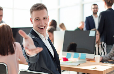 friendly young businessman sitting at his Desk