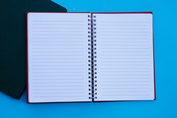 Notebooks on blue background. Top view