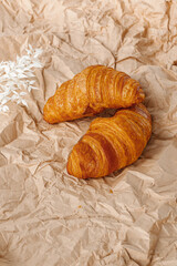 French croissants on craft crumpled paper. Freshly baked butter croissants is a French pastry that eat for breakfast.