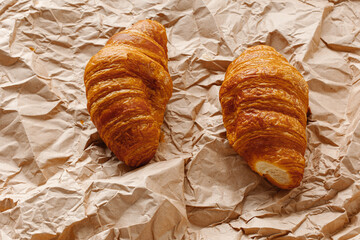French croissants on craft crumpled paper. Freshly baked butter croissants is a French pastry that eat for breakfast.