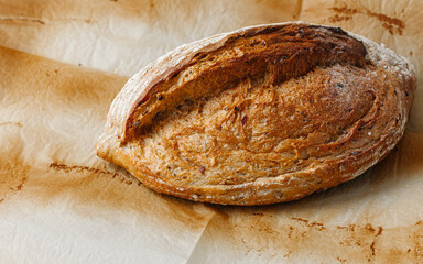 Bakery - golden rustic crispy bread on a background of baking paper. shot from above (top view, flat stripe).