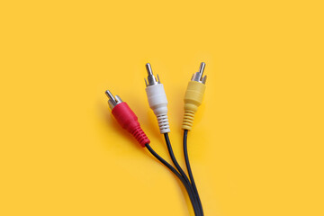 Audio and video cables on yellow background - obrazy, fototapety, plakaty