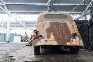 Closeup detail rusty abandoned forgotten antique oldtimer old car handle junkyard factory storage...
