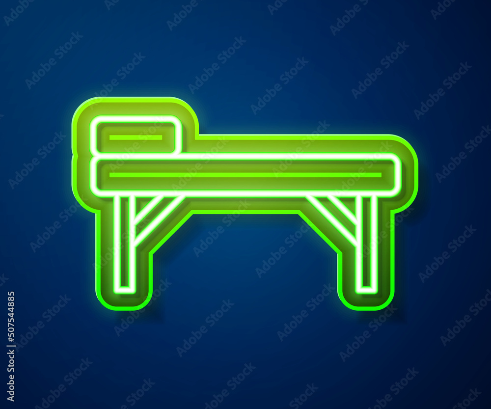 Wall mural glowing neon line massage table icon isolated on blue background. vector