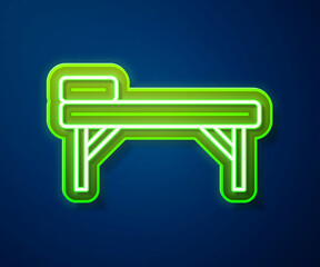 Glowing neon line Massage table icon isolated on blue background. Vector
