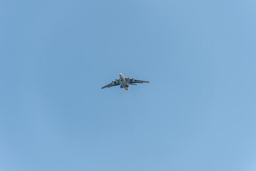 A plane is flying in the clear blue sky