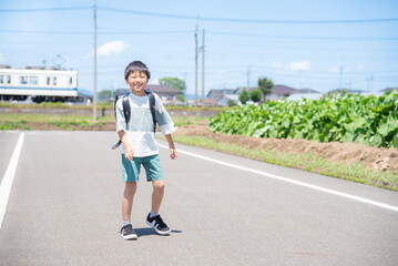 学校から帰宅中のアジア人の小学生の男の子