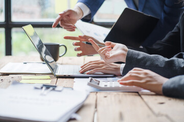 Close up businessman hand using calculator and working with laptop calculate about finance accounting at coffeeshop outdor.finance accounting concept