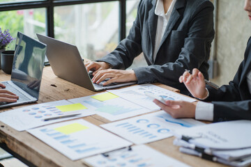 Close up businessman hand using calculator and working with laptop calculate about finance accounting at coffeeshop outdor.finance accounting concept
