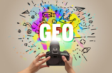 Close-up of a hand holding digital camera with abstract drawing