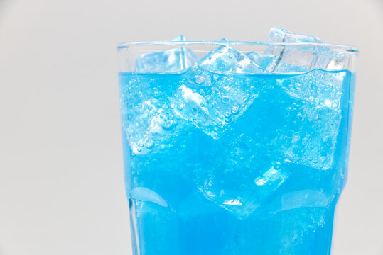 Blue Hawaii sparkling water with ice cubes close-up.