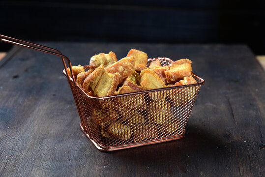 delicious fried pork rinds, typical Brazilian food served in a metal basket