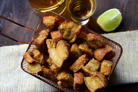 delicious fried pork rinds, typical Brazilian food served in a metal basket