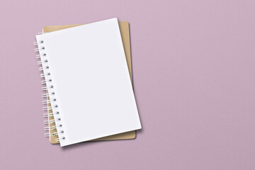 The notebook is located on a pink paper background.