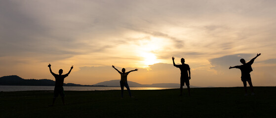 Silhouette of Happy Four People Travel at Countryside at Sunset During Summer Vacation