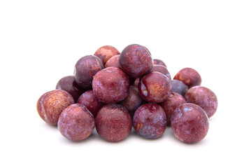 Purple plums on white background