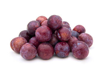 Purple plums on white background