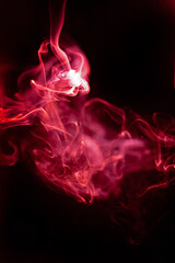 Fototapeta premium Red smoke motion on black background.