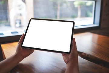 Fototapeta Mockup image of a woman holding digital tablet with blank white desktop screen obraz