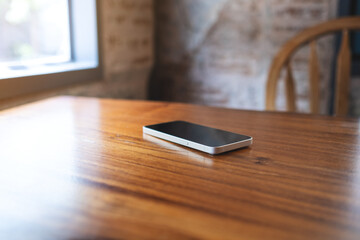 A single mobile phone on wooden table