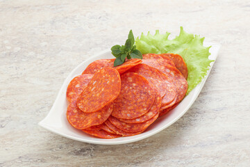 Sliced pepperoni sausage in the bowl