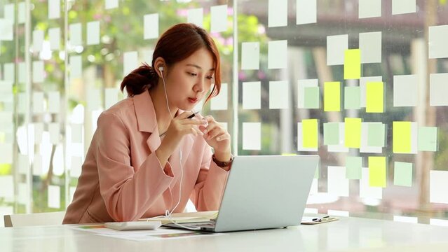 Business Woman with business partner via video call on laptop, she is meeting with partner on planning, operations and finance of a joint startup company. Business administration concept.
