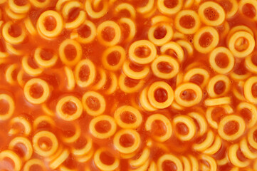 Spaghetti hoops in a juicy tomato sauce food background