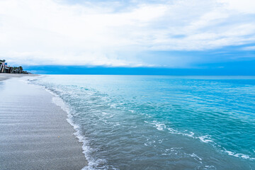 Fototapeta premium Sunrise in Florida. Calm blue ocean and white sand beach