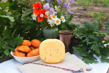 June 23-24 in Latvia, the national Ligo holiday. Traditional Latvian food cheese with cumin Ligo celebration in June decorates the house with a bouquet of wildflowers. Symbols of Latvia - obrazy, fototapety, plakaty