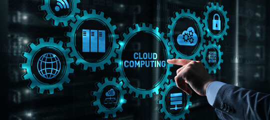 Cloud computing concept. Businessman is pressing on the virtual screen inscription Cloud computing