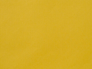 Golden yellow background of a sheet of paper with texture. Vintage cardboard texture Bright shade of yellow, close to straw or gold