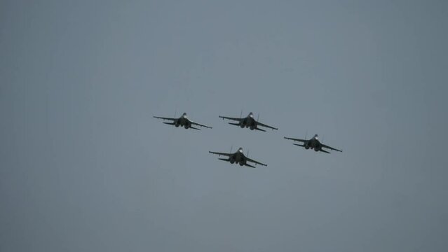 Supersonic fighter jets team in formation flying in the sky. Military aviation. Russian jet military aircraft Flanker-E at airshow. Fighting falcon