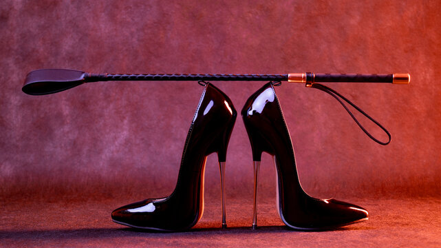 Black shiny high heel shoes and a whip on a dark background