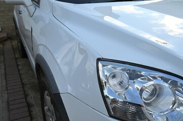 The vandalised front wing of a car. 