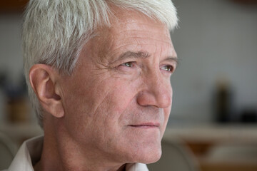 Close up shot sad thoughtful silver haired elderly man pensioner look aside troubled with bad...