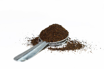 Black Tea Powder or dust with or without green leaf and served hot chai in a cup. Black Tea powder in the spoon isolated on white background 