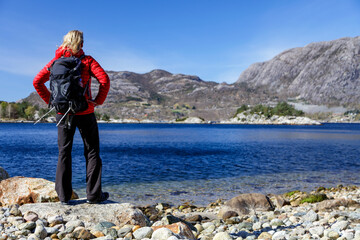 Norway female hiker beside a remote glacial fjord