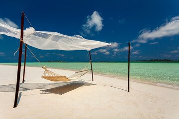 Beach hammock on shoreline a remote luxury paradise